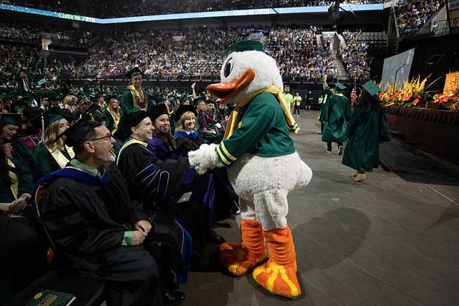 The Duck shaking hands with graduates in Matthew Knight Arena The Duck shaking hands with graduates in Matthew Knight Arena
