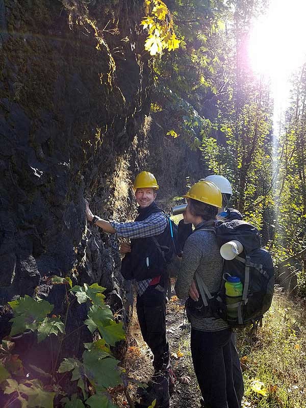 Researchers inspecting a hillside