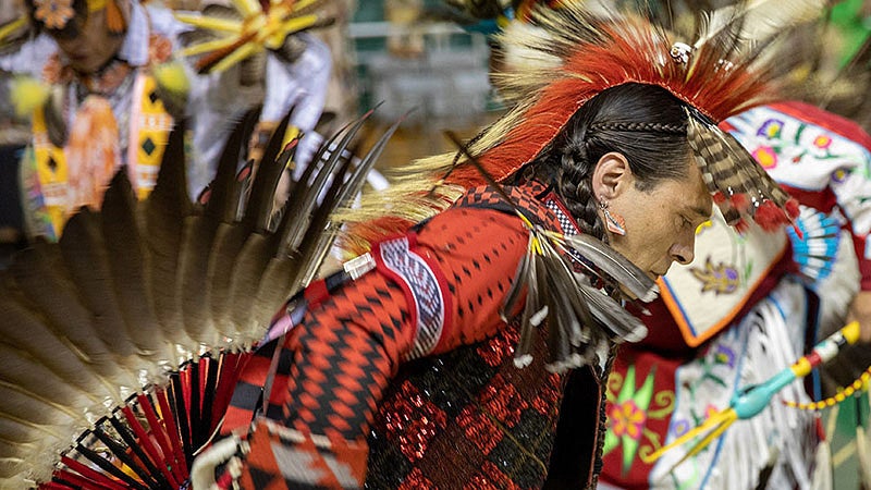 A dancer at the UO Mother's Day Powwow dancing in native regalia