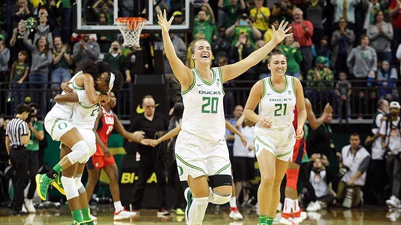 Sabrina throws her hands up in celebration at beating the USA women's national team