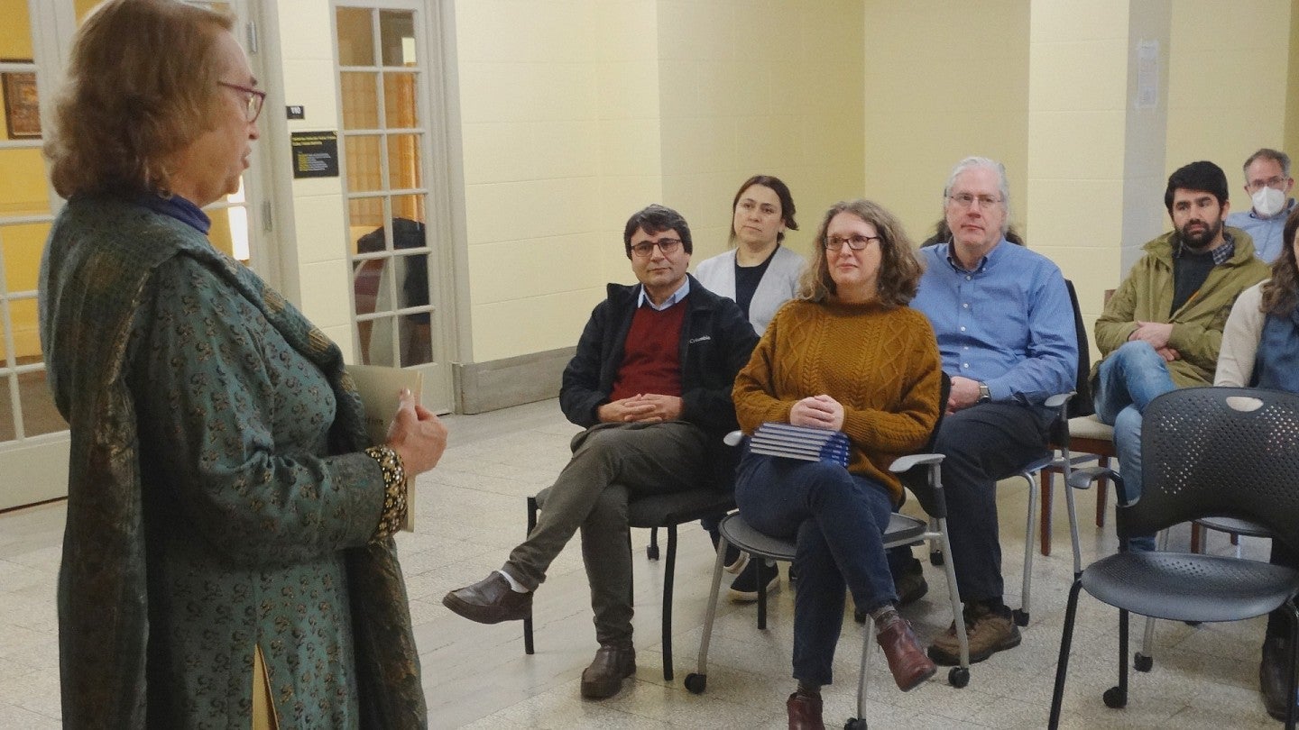 Anita Weiss (standing) at a farewell ceremony for the six visiting KIU faculty members.