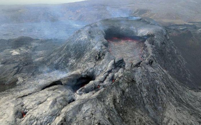 Initial state of the volcano eruption, smoke lightly pouring out of the caldera