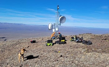 Oregon Hazards Lab team members install a wildfire camera tower at the nearly 8,000-foot peak of Beaty Butte