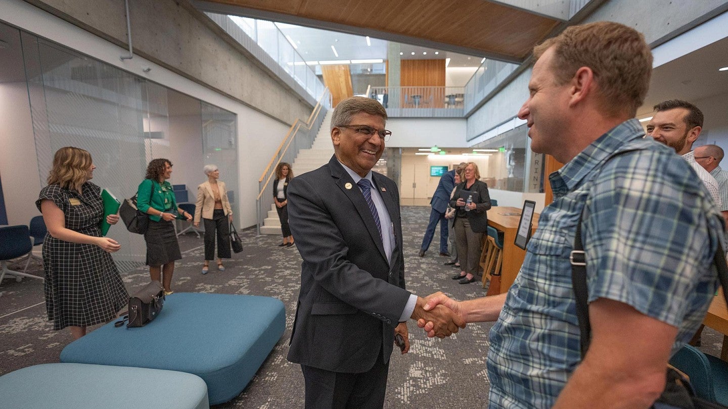 NSF Director Sethuraman Panchanathan shakes hands with a colleague