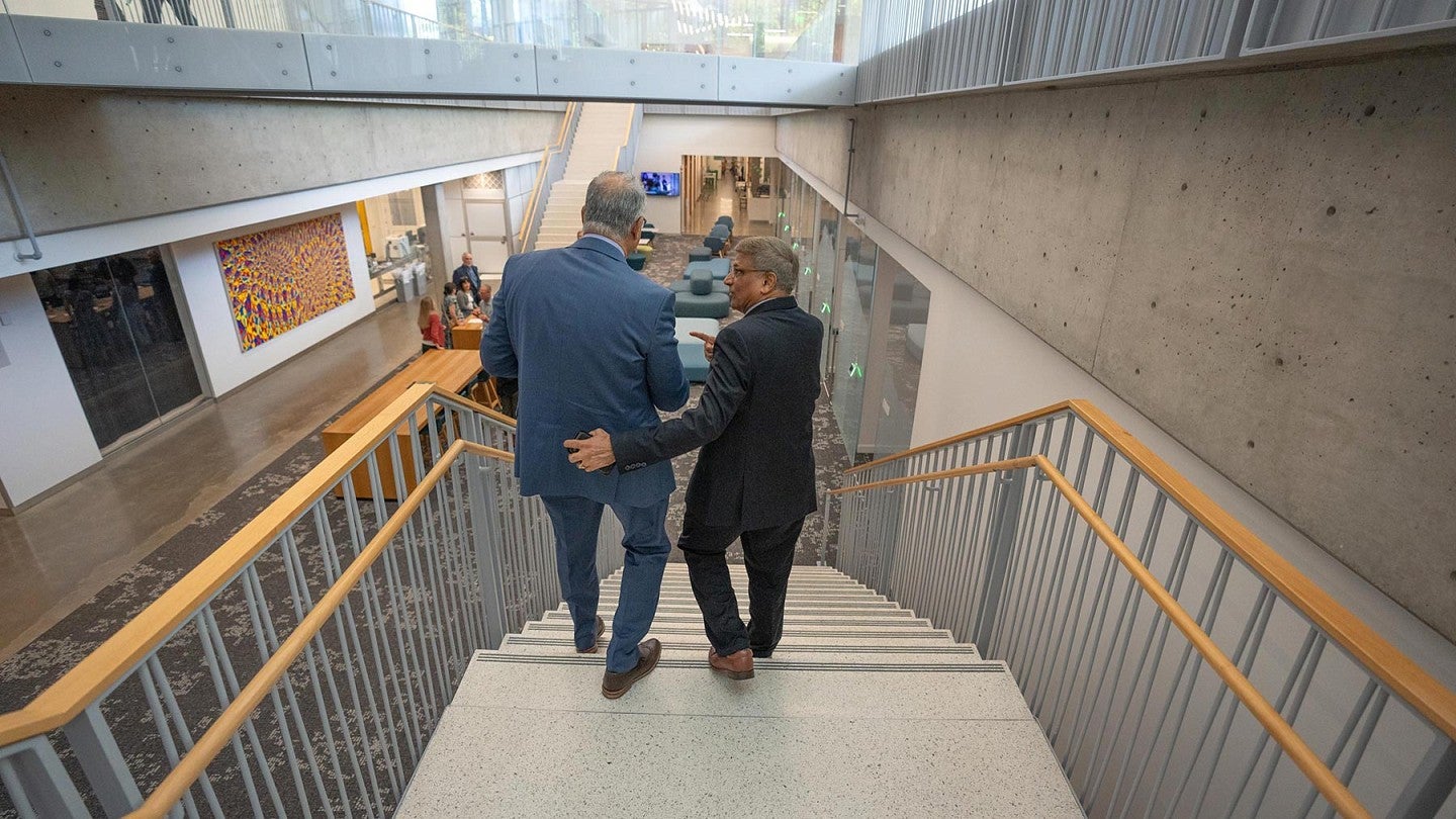 NSF Director Sethuraman Panchanathan walks down a stairway with a colleague