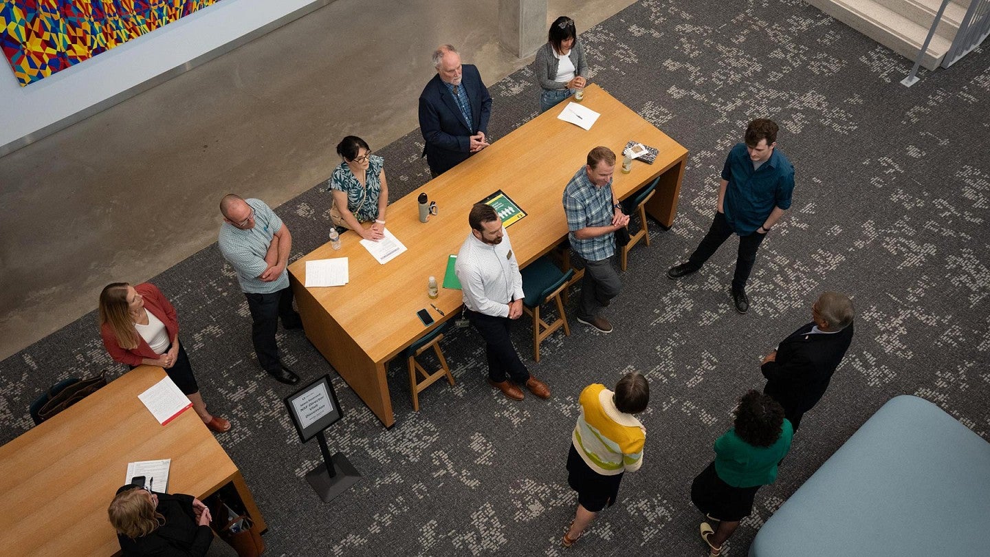 NSF Director Sethuraman Panchanathan speaks with colleagues during his visit to the UO Eugene campus