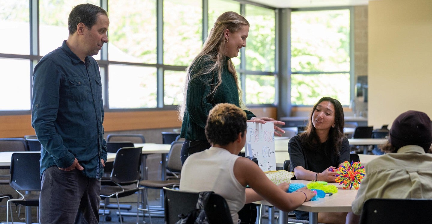 Ballmer Institute faculty, staff, and students with middle school students in a classroom setting