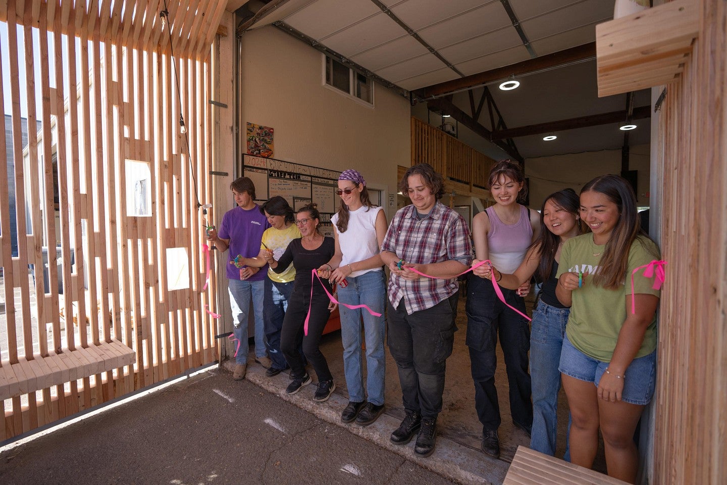 Students cutting the ribbon to the new house they helped construct during the Bruton Design Intensive