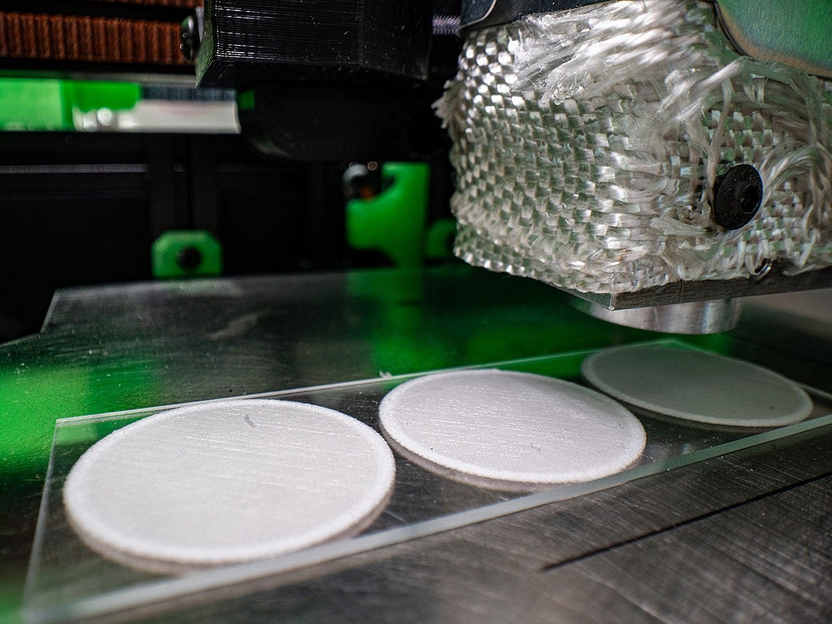 three white discs created by a 3D printer