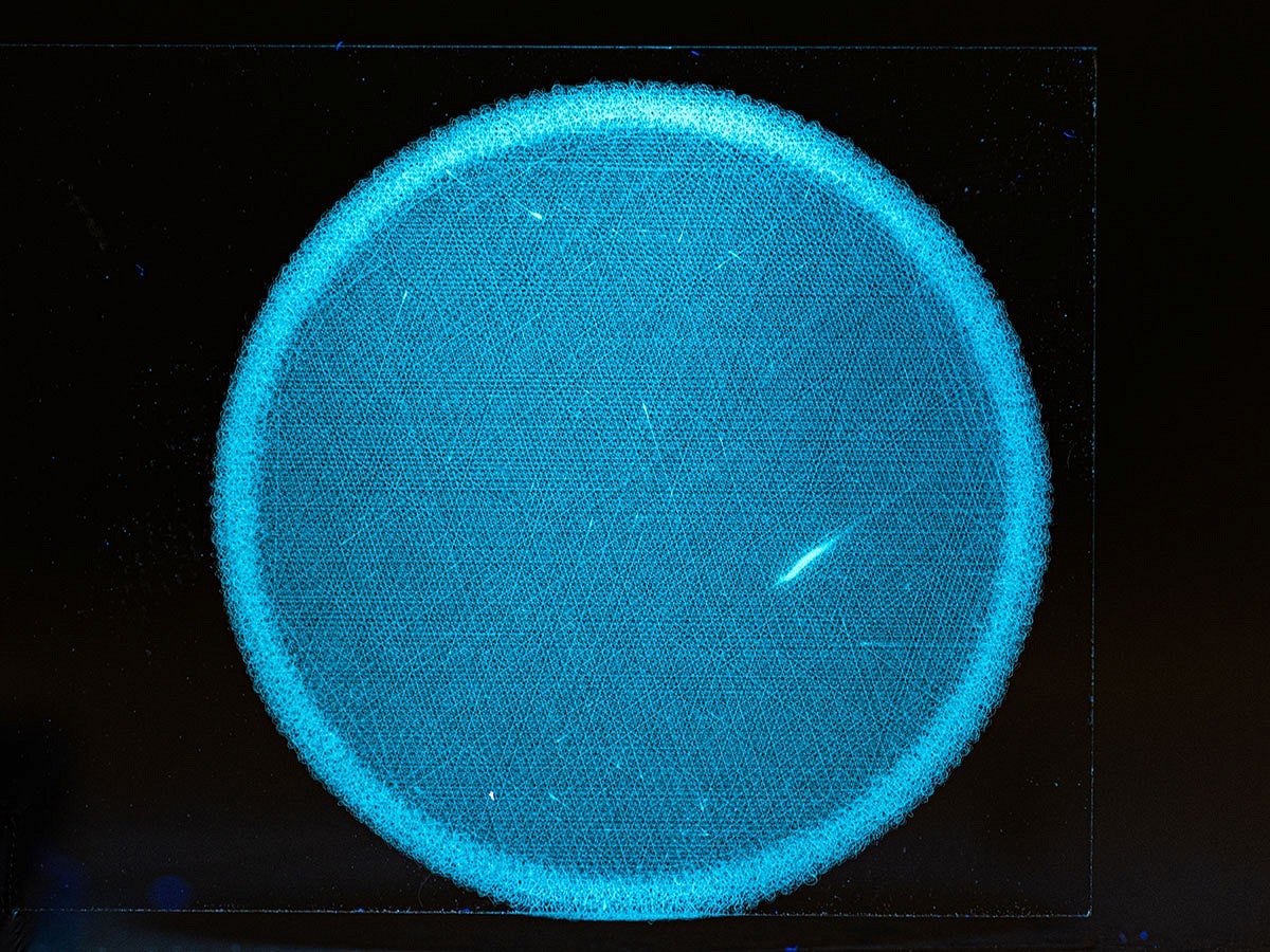 Close-up view of a glowing blue disk against a black background