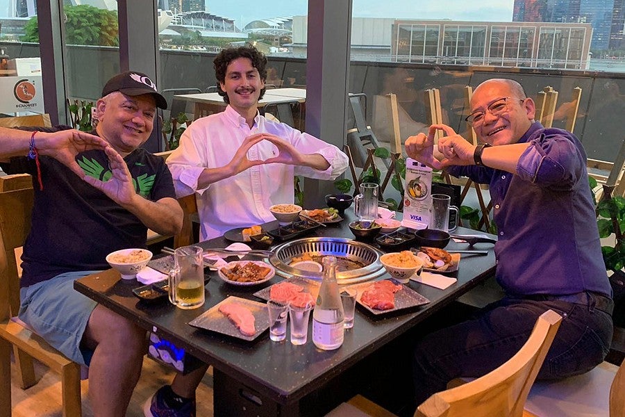 UO intern Spencer Erspamer and colleagues in Singapore throwing their O's over a business lunch.