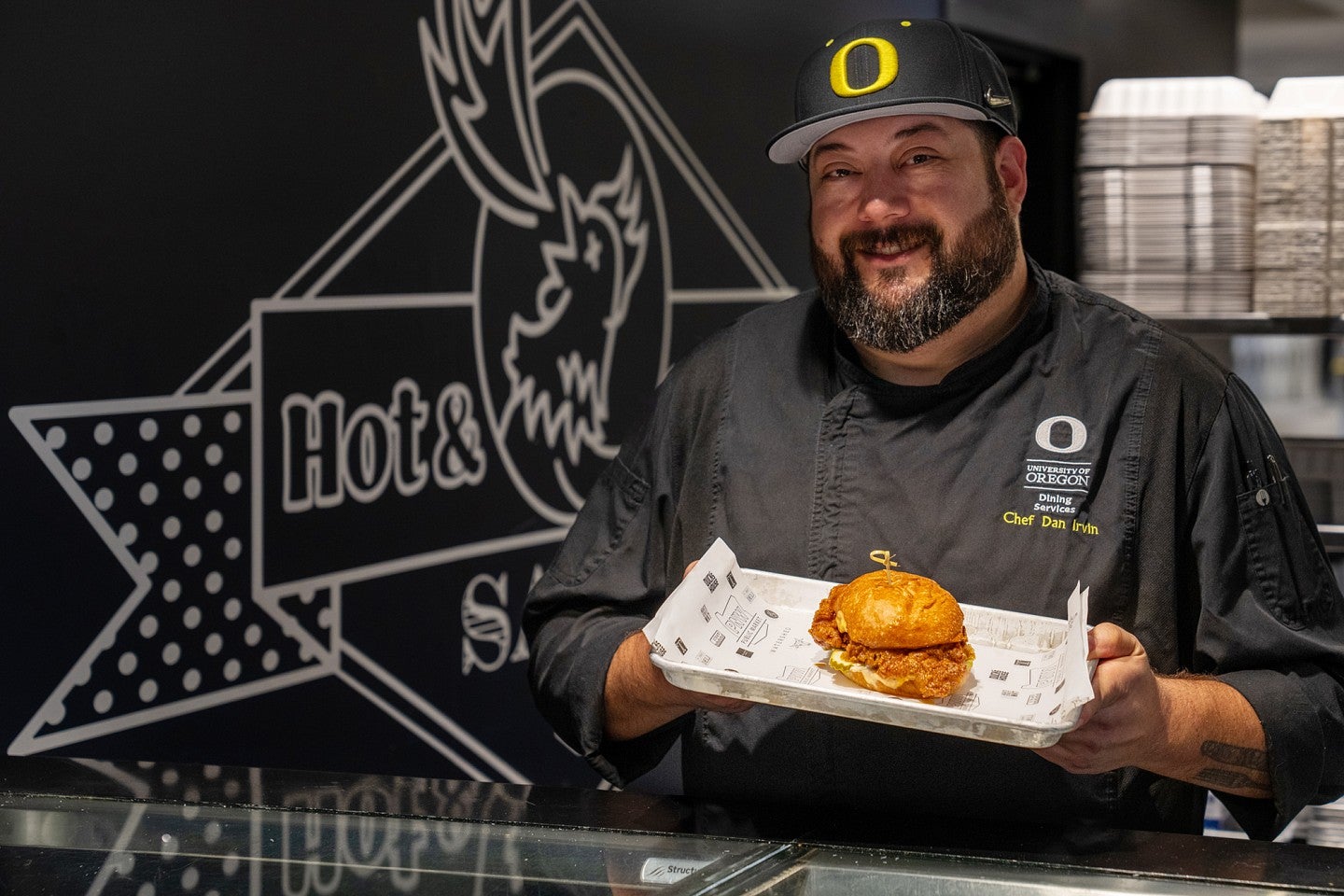 Dan Irvin holds a chicken sandwich from Drake's Deli in Unthank Hall