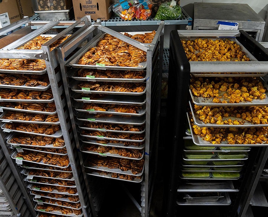 Metal trays of food in a dining hall