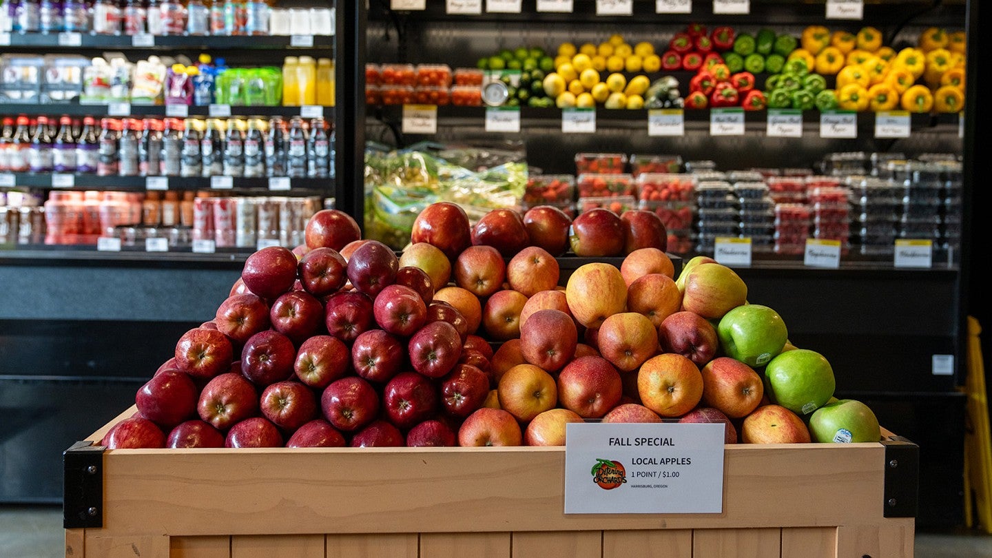 Apples stacked in a bin in a campus market