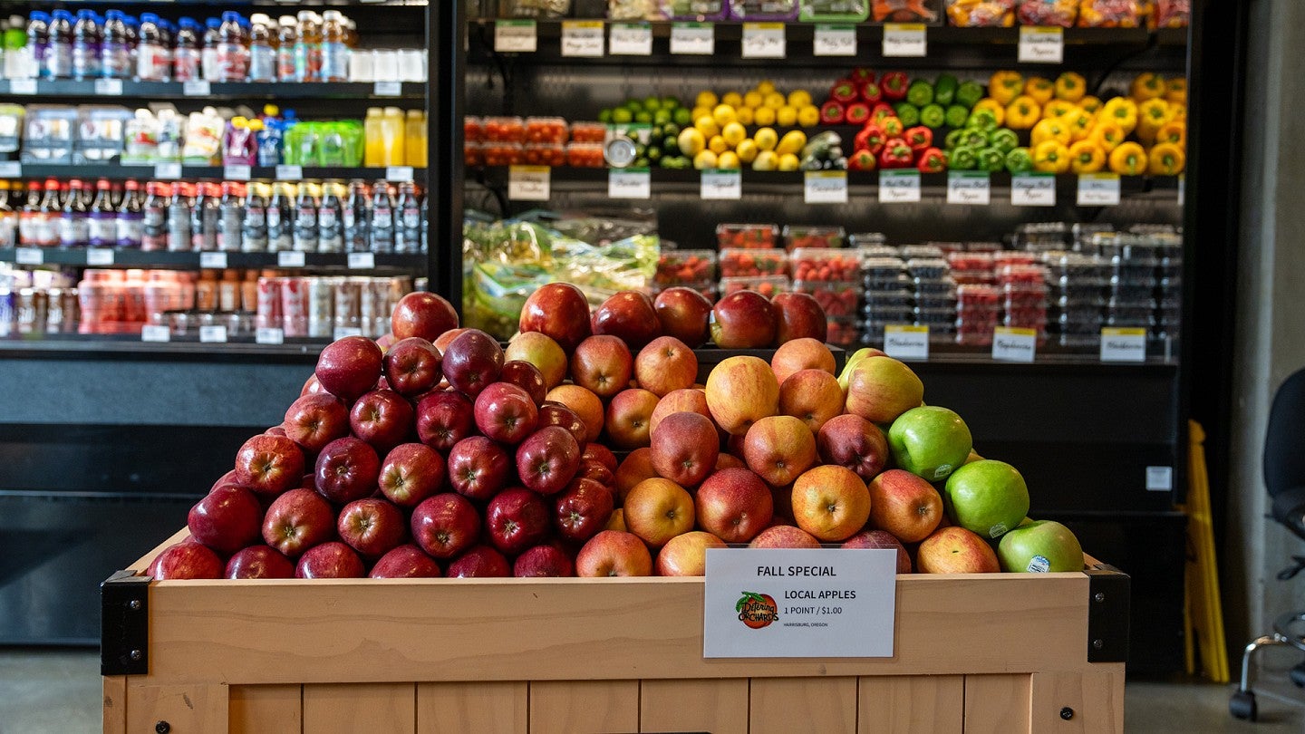 Apples stacked in a bin in a campus market