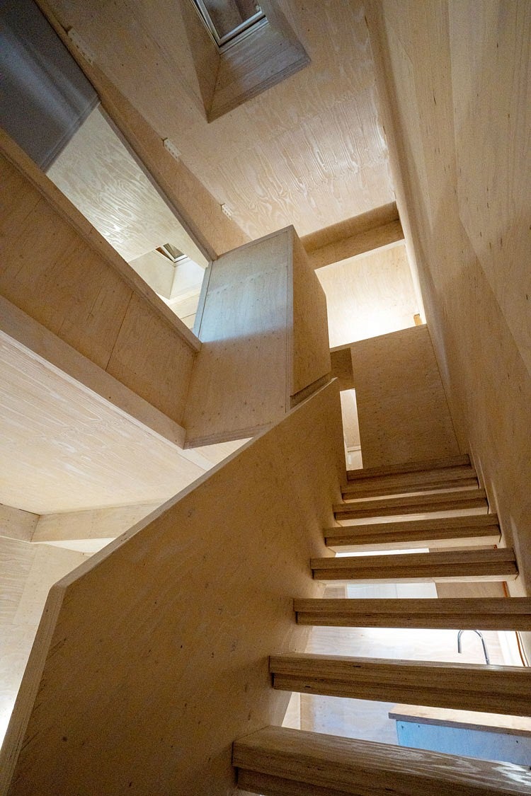 a stairway inside the prototype house leads to upper rooms