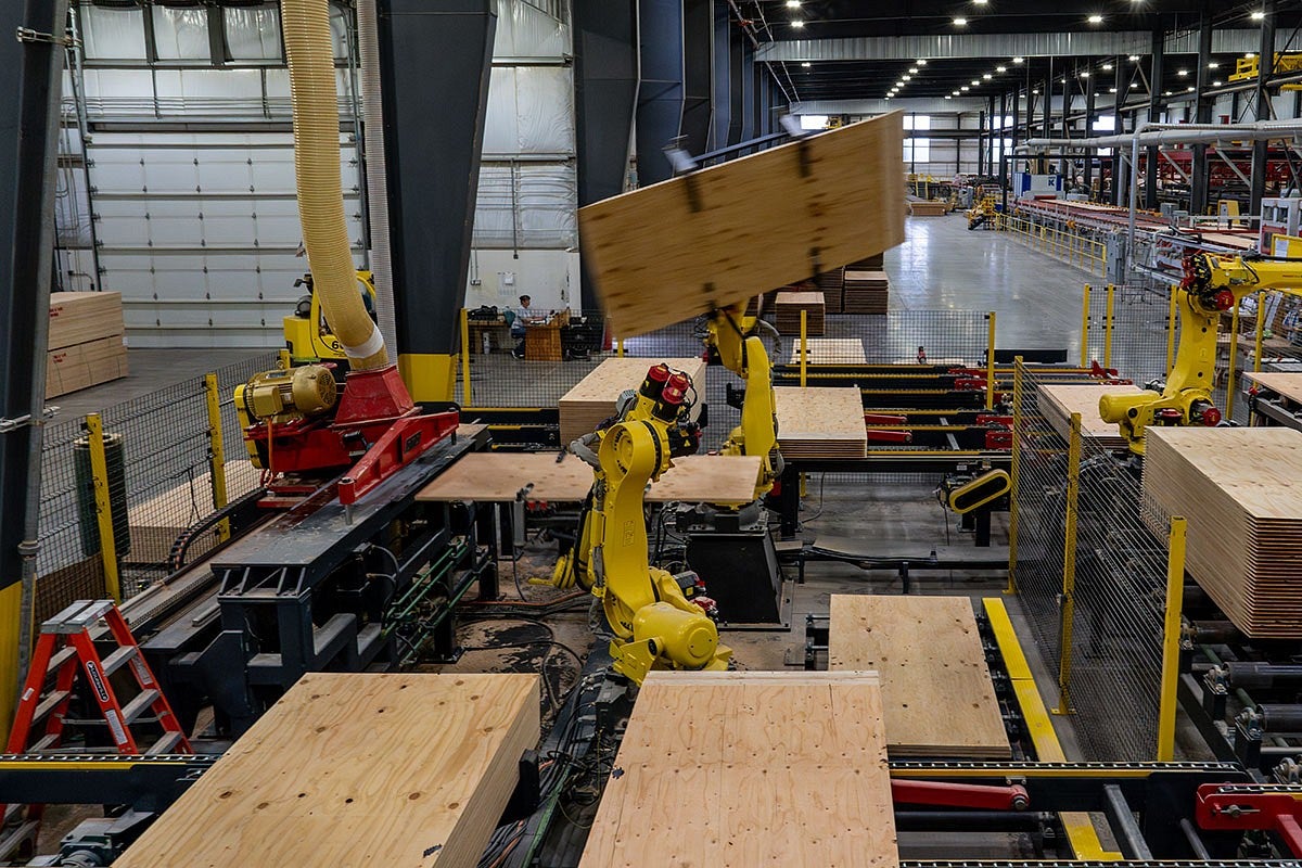 robotic arms move sheets of plywood