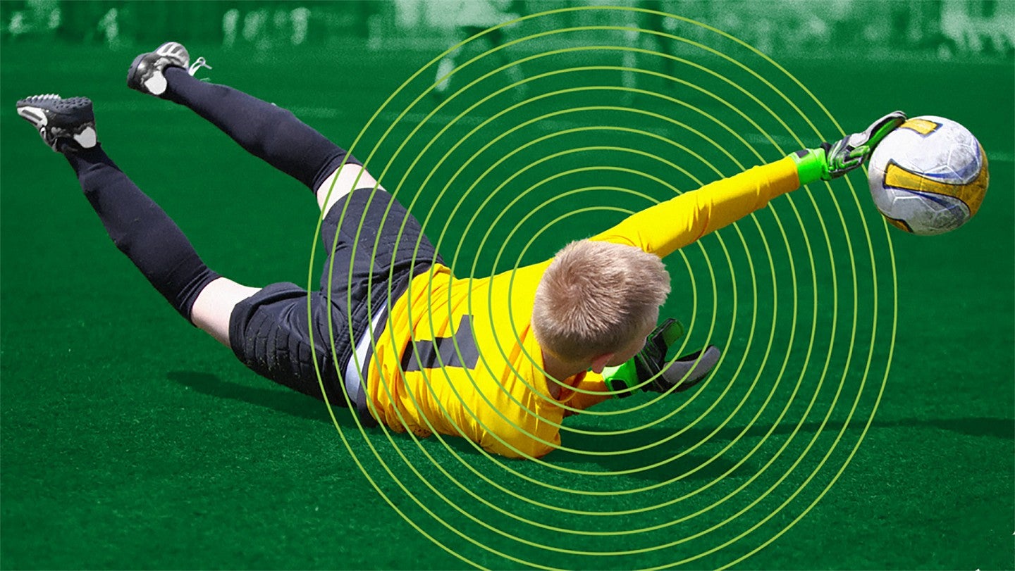 Youth soccer player falling on field, circles radiating from his head