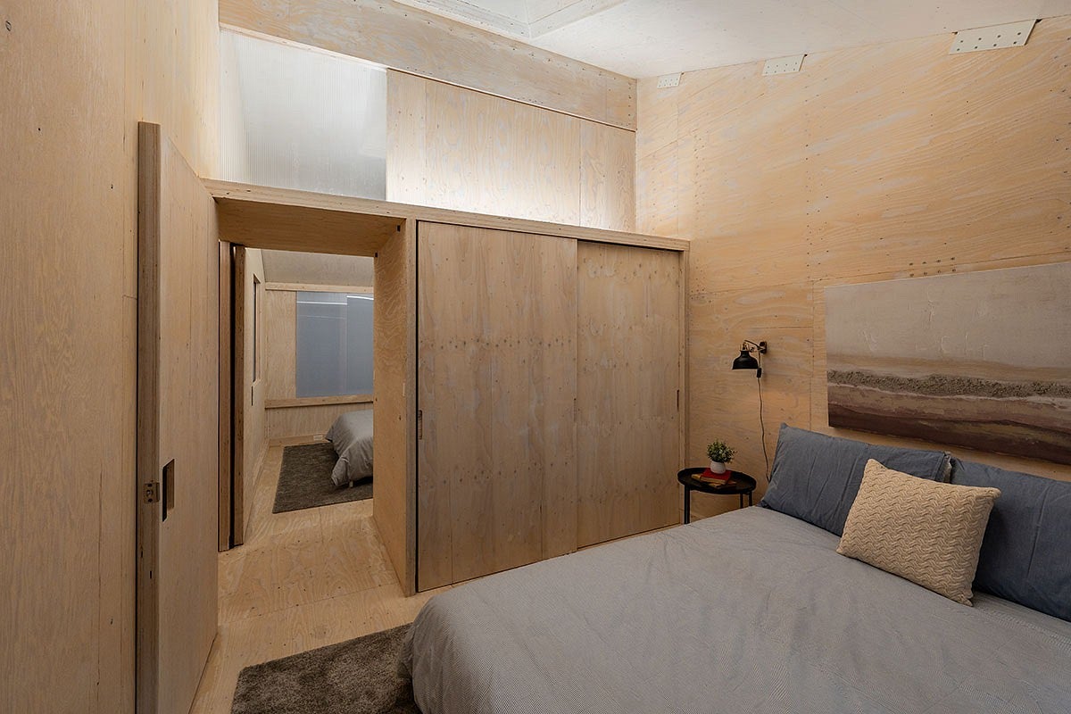 staged bedrooms inside a prototype mass plywood home
