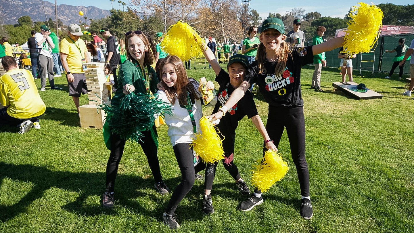 Four kids in Oregon Duck gear at the Alumni Tailgate