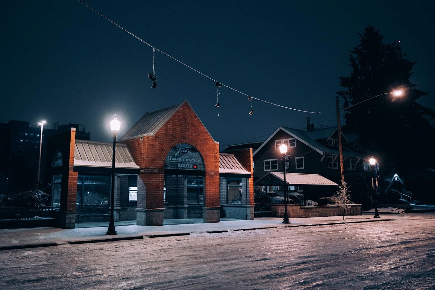 a bus stop on the UO Eugene campus at night with surfaces covered in ice