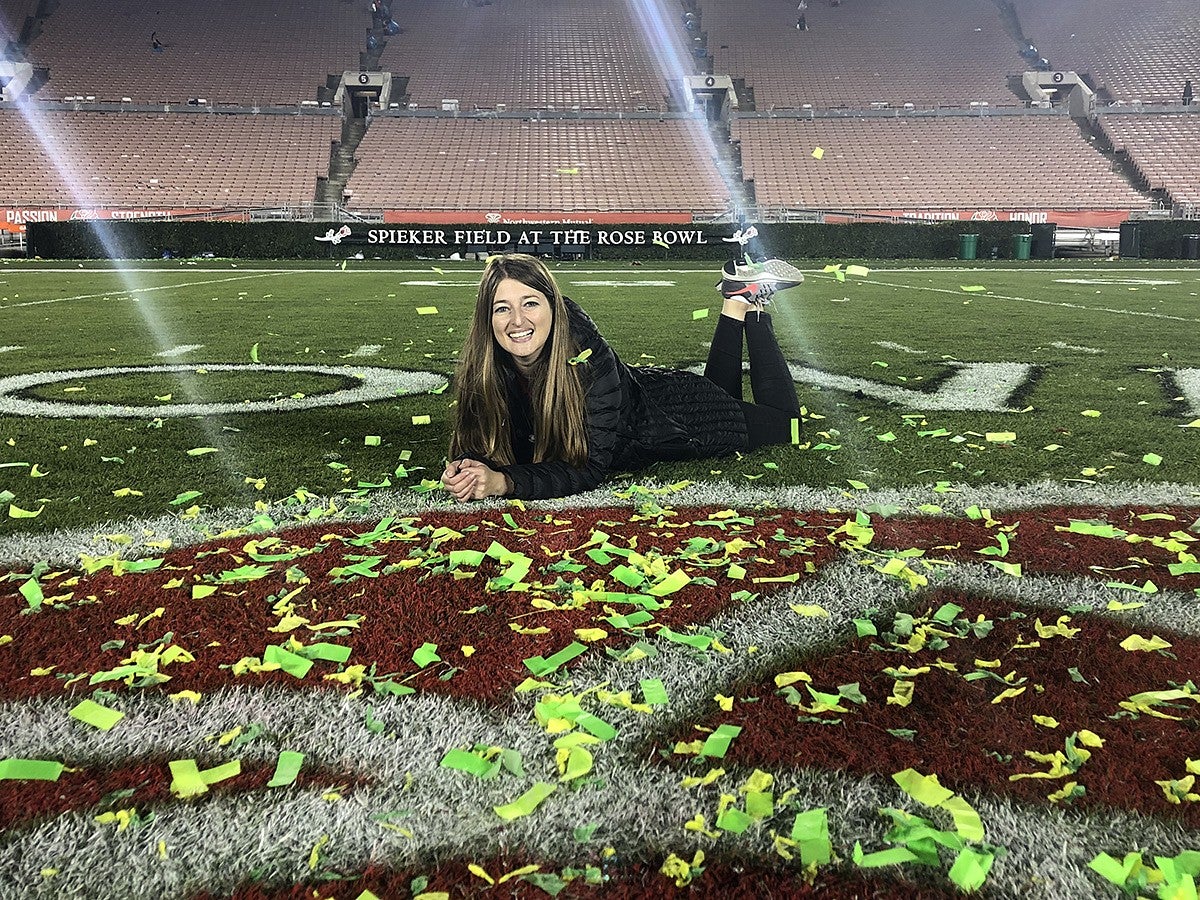 Julia poses for a photo on the field at the Rose Bowl