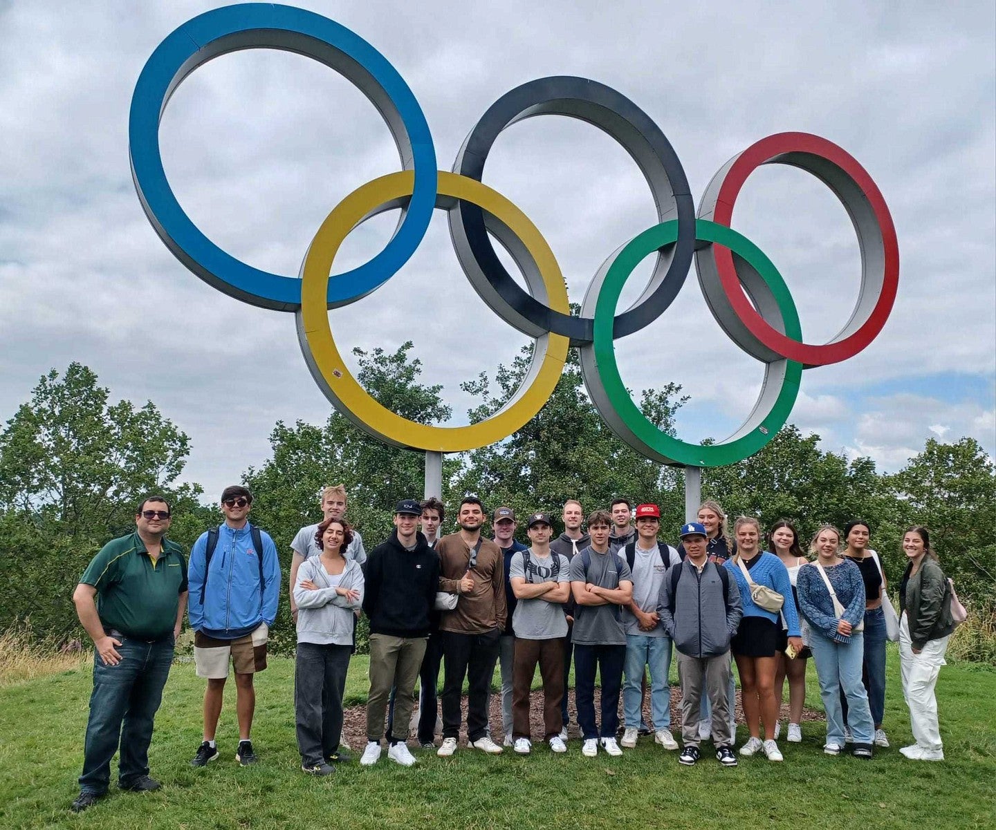 Yoav Dubinsky and students in London standing next to the Olympics sign