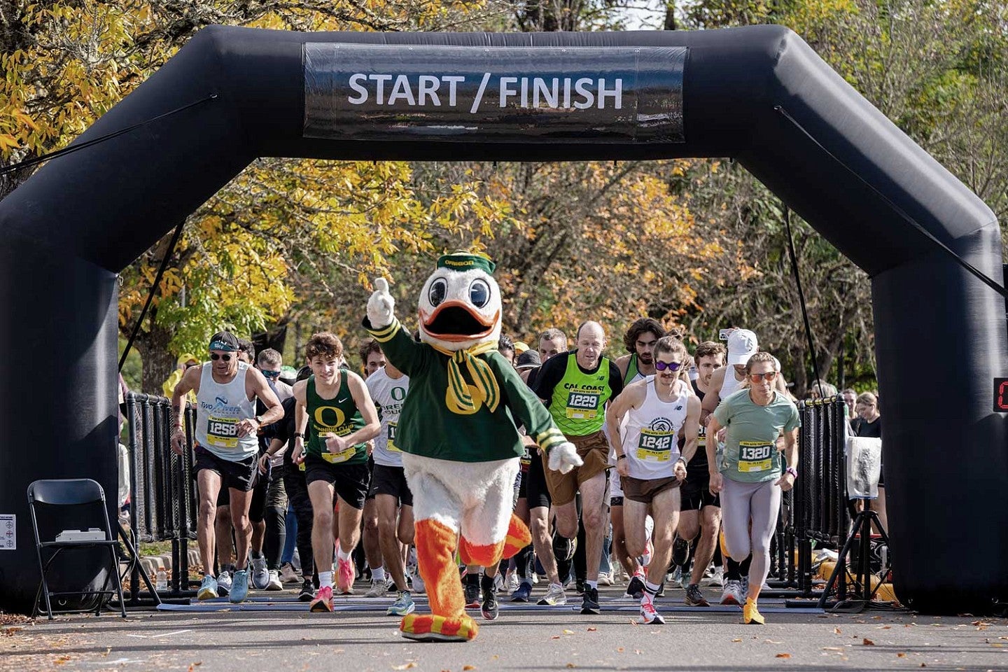 The Duck leads a group of runners through the Start/Finish line