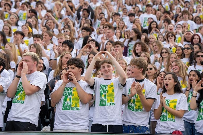 Students in their Class of 2029 t-shirts cheer in the stands at Autzen Stadium