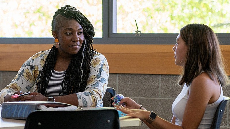 a faculty member talks with a student