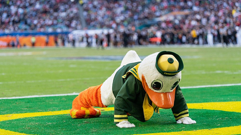 The Oregon Duck doing pushups on the football field