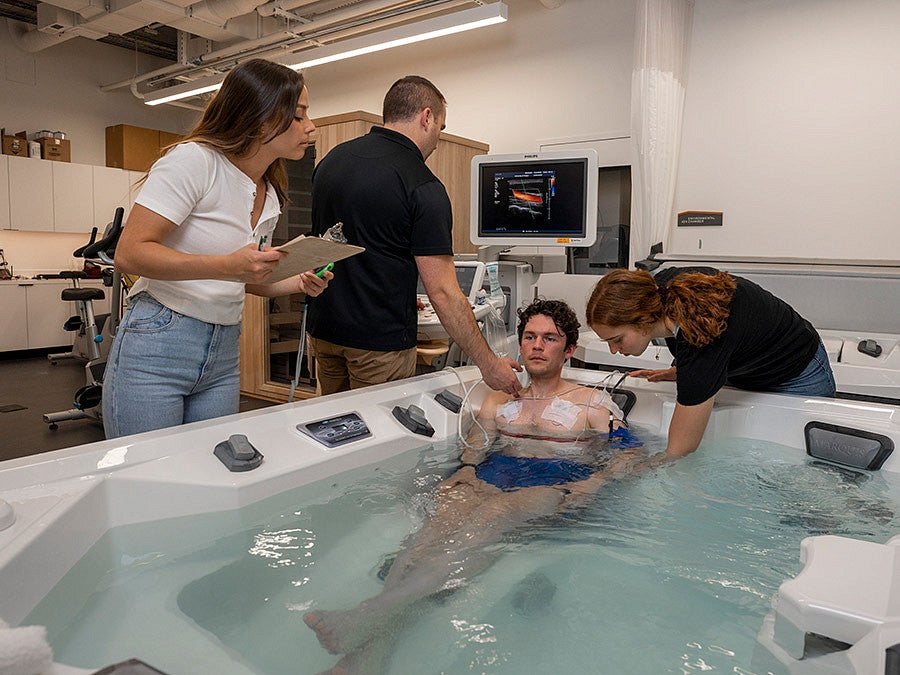 scientists gather data on athlete in hot tub