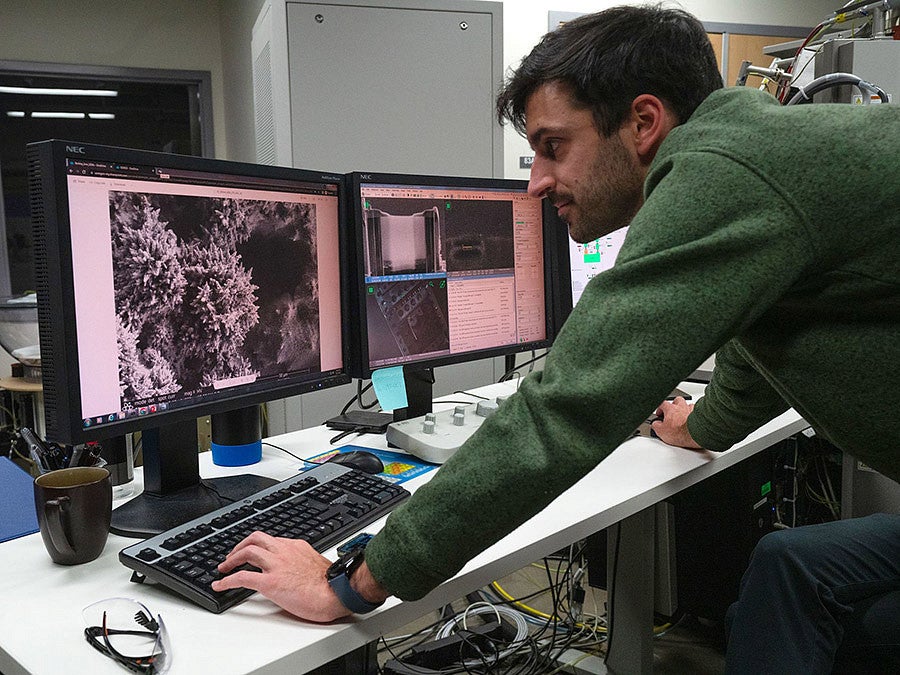 Paul Kempler examines scanning electron microscope images