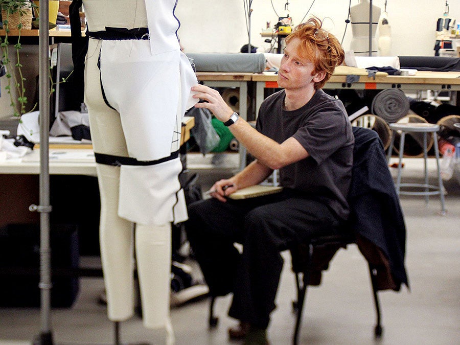Jacob Kauff adds fabric to a mannequin