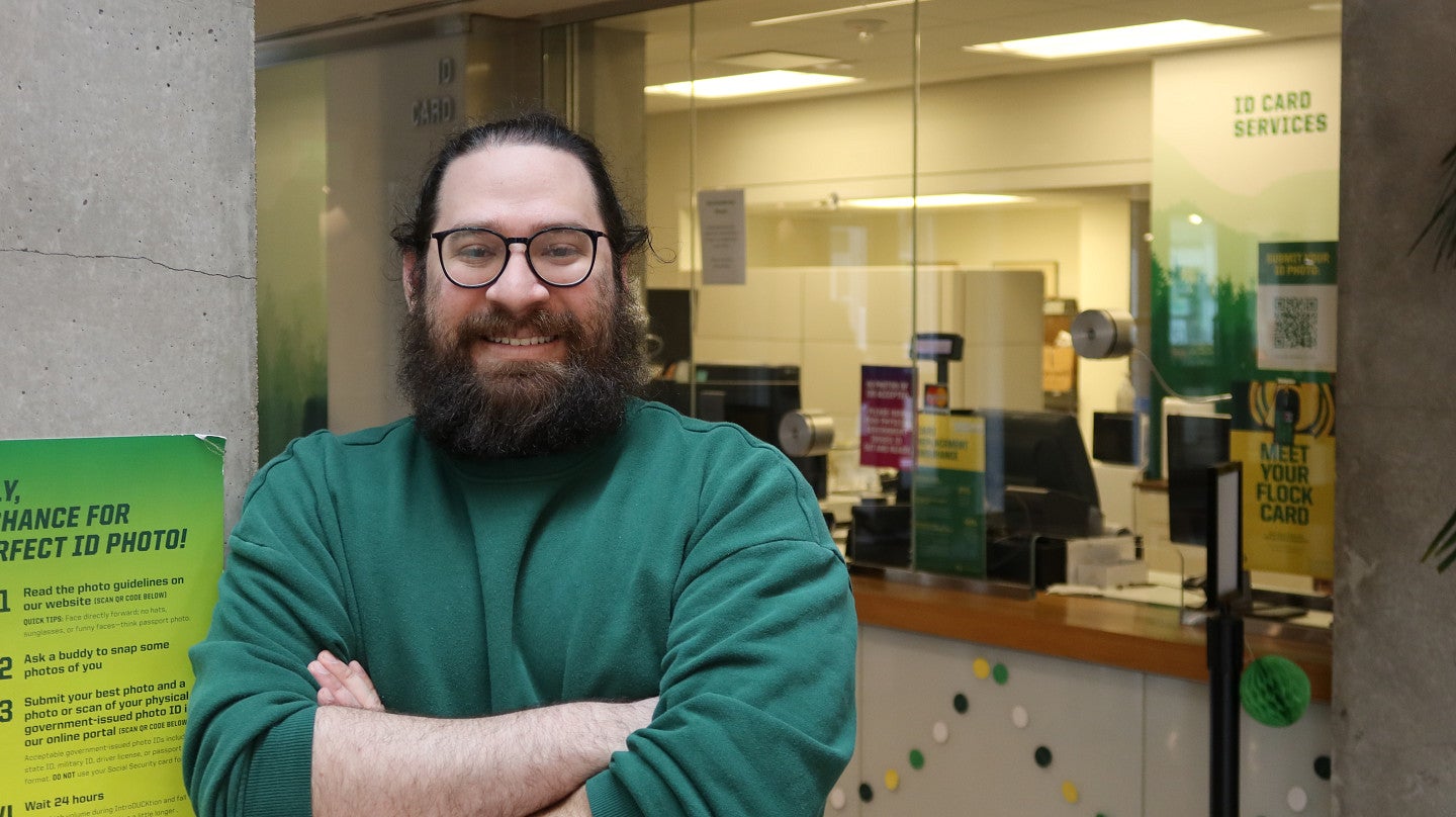 A man leans against a column in the student union