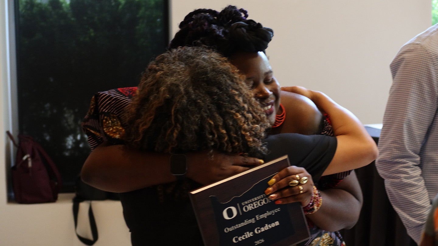 Licensed psychologist Cecile Gadson gets a hug from Ceara Wilson of University Communications