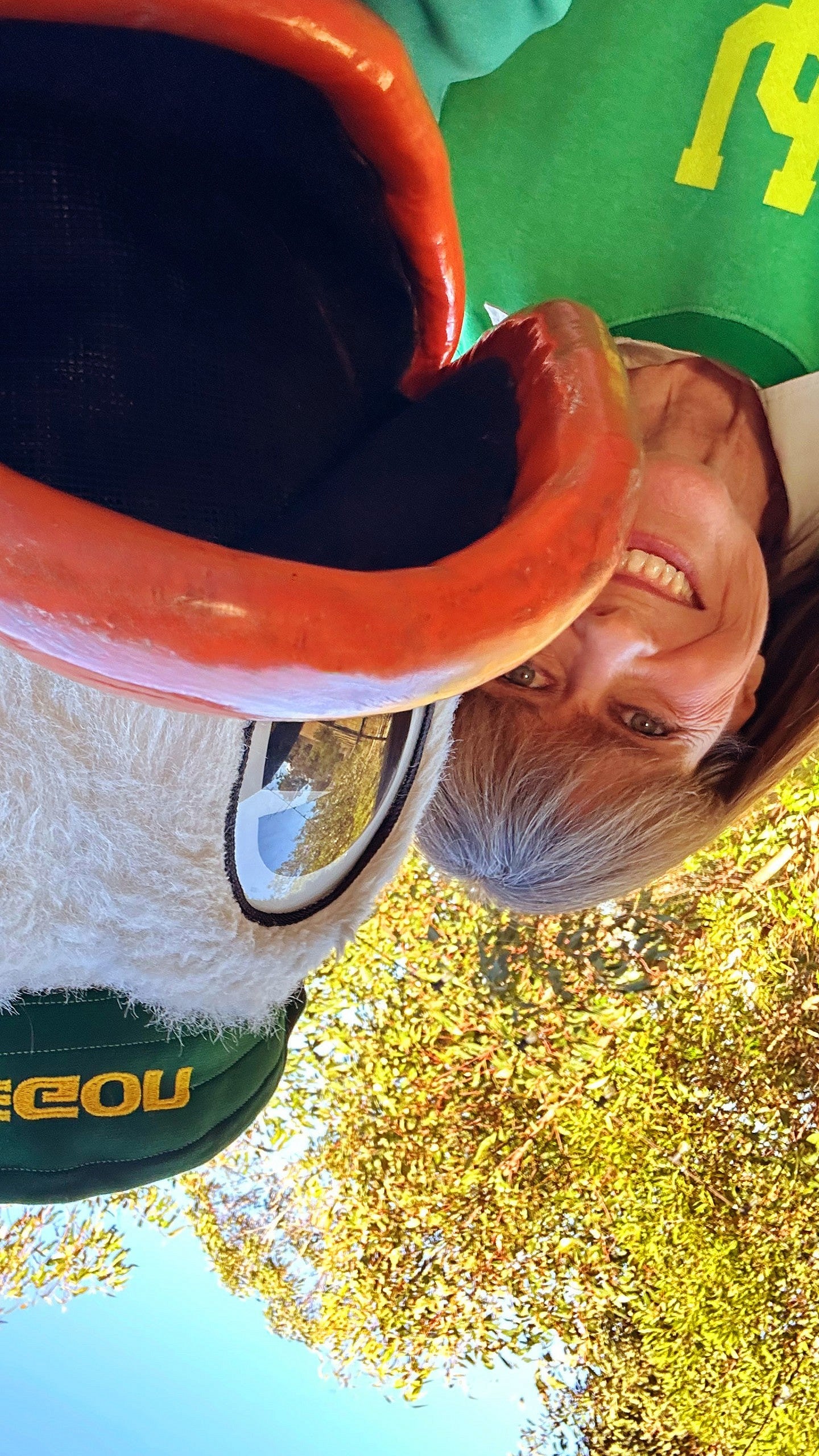 An upside down photo of the Oregon Duck taking a selfie with Terri Irwin