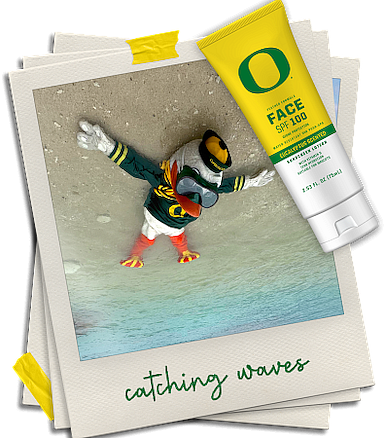 Upside down photo of the Oregon Duck laying in the sand on the beach