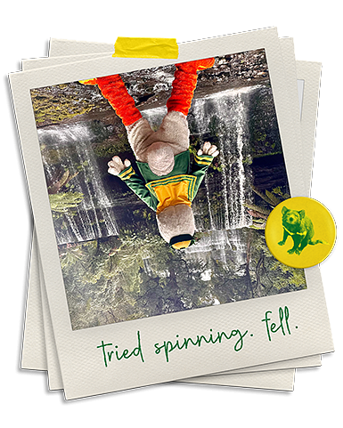 Upside down photo of The Duck standing in front of a waterfall