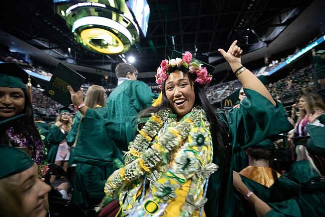 A graduate decked out in leis during the commencement ceremony A graduate decked out in leis during the commencement ceremony