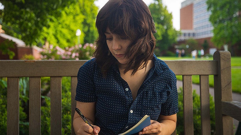 Andi Butts writing in a journal