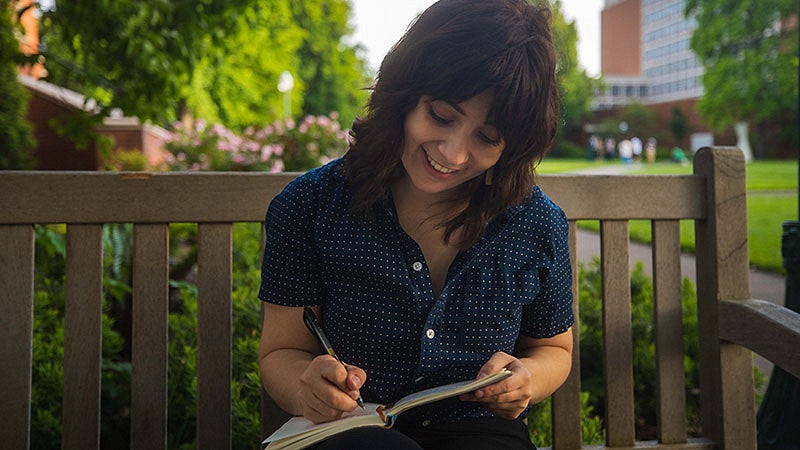 Andi Butts writing in a journal
