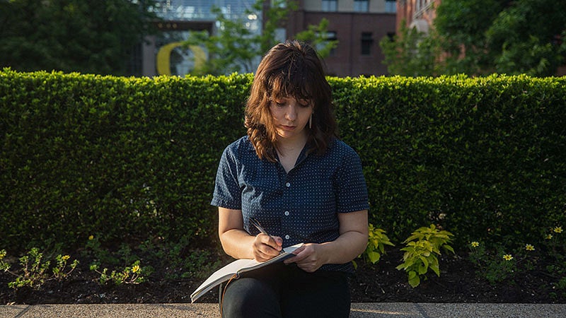 Andi Butts writing in a journal