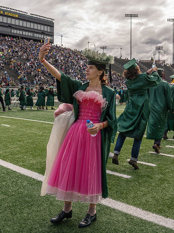 Student taking a selfie at the 2022 UO graduation at Autzen Stadium