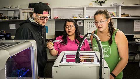 Working on the 3D printer in the MakerSpace