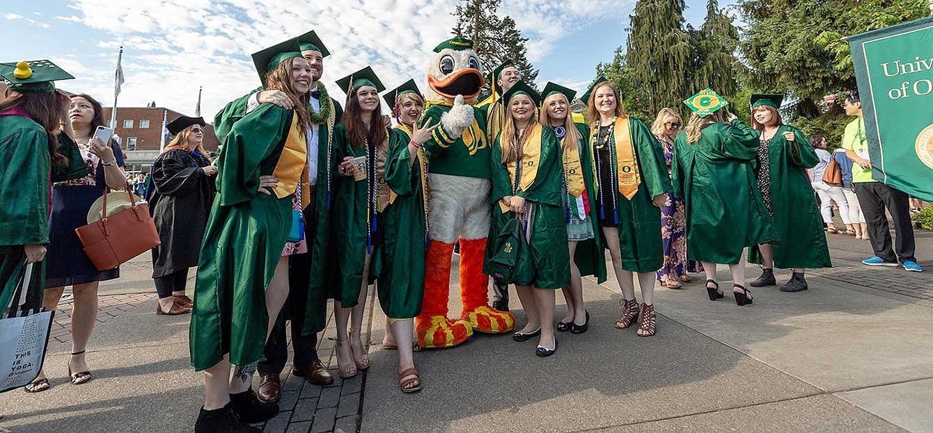 Graduates take a photo with the Duck before the 2018 grad parade Graduates take a photo with the Duck before the 2018 grad parade