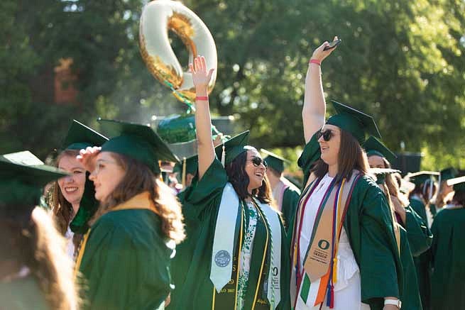 Graduates celebrating during the Duck Grad Parade Graduates celebrating during the Duck Grad Parade