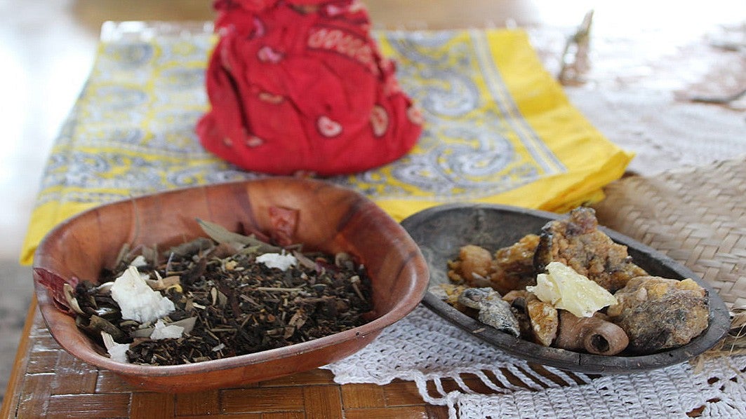 Bowls of herbs sitting on a table