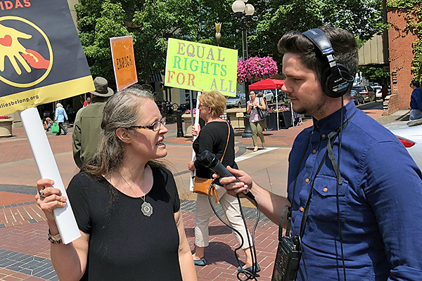 a student journalist records a person at a rally