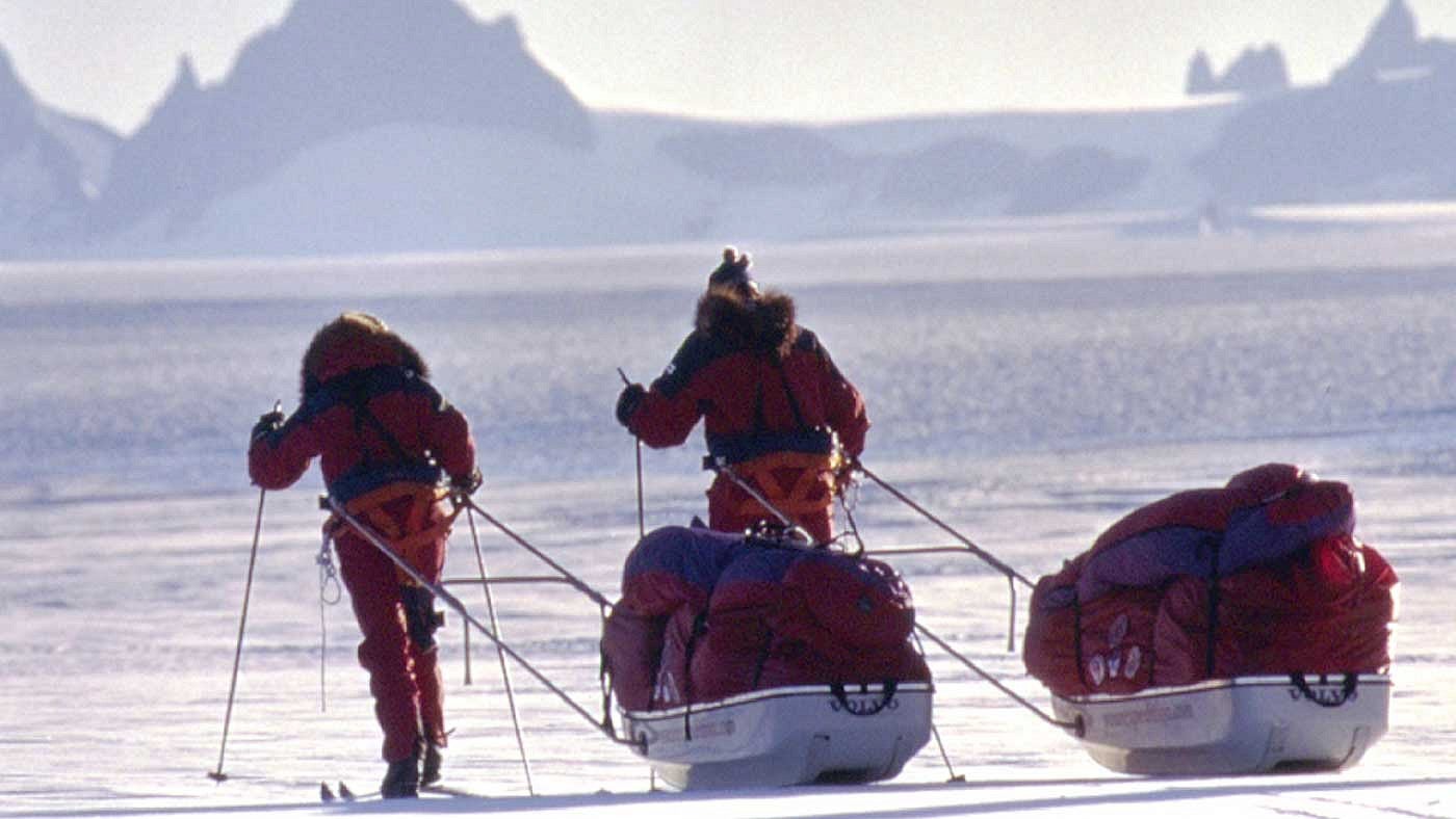 Ann Bancroft and Liv Arnesen pulling sleds on the Antarctic Crossing 2000